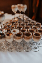 Catering. Drinks on wedding party. Cocktail glasses full of red alcohol stand on table.
