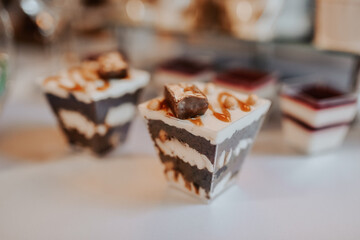 stylish desserts with strawberry, candy bar with sweets at luxury wedding reception.