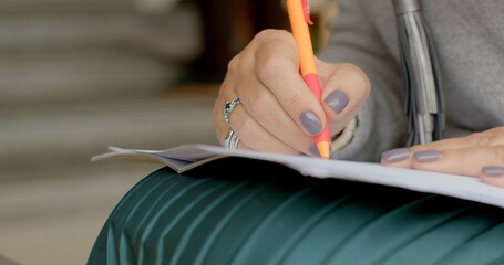 Hands with pen close-up making notes. People brainstorm ideas and strategies in casual environment. Modern workplace dynamics, effective communication in informal settings. 