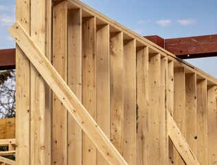 An interior wood framing 2x6 inch stud wall showing the studs and plywood sheathing and temprary...
