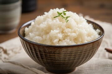 Closeup view bowl of cooked rice showcased on kitchen table