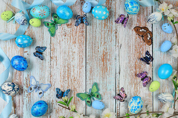 Happy Easter concept, Composition with decorated Easter eggs, butterflies and apple tree branches....