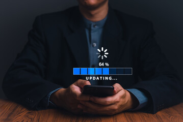 A user patiently awaits completion as a progress bar on a smartphone indicates a technology update.