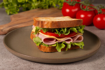 Close-up of two sandwiches with bacon, salami, prosciutto and fresh vegetables on rustic wooden cutting board. Club sandwich concept - 752430925