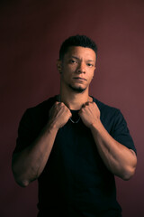 Sensual looking African American young man with board background