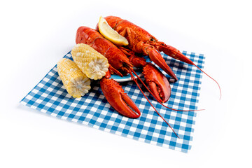 Lobsters on a plate on blue checked place mat isolated on white