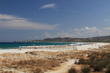 Fototapeta premium Turquoise sea water , white sand and blue sky in the beautiful beach of La Caletta, Siniscola in Sardinia, Italy