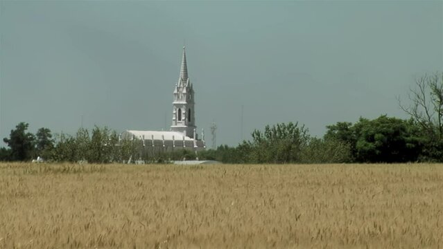 A Wheat Field and San Jose Church in the Distance in the Province of Entre Rios, Argentina. 