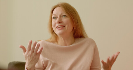 Woman talking about relief surge of strength and energy following session with psychotherapist. Portrait of happy, energetic woman expressing gratitude to therapist. Feedback to mental health service.