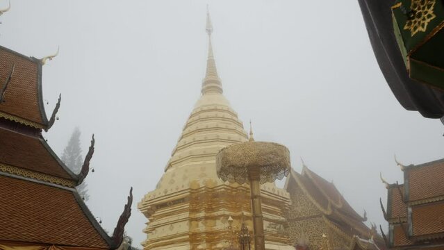 view at Suthep temple with famous giant golden pagoda among fog cloud natural landscape,Wat Phra That Doi Suthep temple