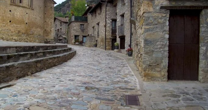 Walking the cobbled streets of Beget, a medieval small town in Catalonia, that belongs to the association The Most Beautiful Towns in Spain. Camera movement, subjective vision. 4K+ resolution.