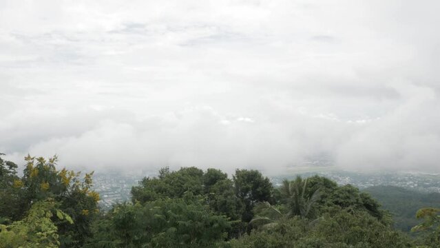 view of the local city of chiangmai from mountain hill under the cloud and fog level