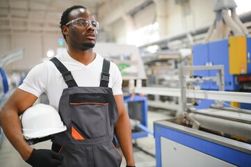 Portrait of industrial engineer. factory worker standing in factory production line