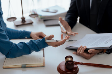 Lawyer discussing a contract with a client. Legal consultation and agreement review concept.