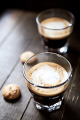 Two Glasses of Coffee with Milk on dark wooden background.	