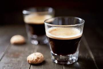 Two Glasses Of Coffee on dark wooden background. Close up.	