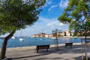 nice view of the sunny city of Rovinj with the adriatic sea and boats from sidewalk