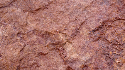 Empty red brown grain stone wall on cave for abstract  background and texture. beautiful patterns, space for work, banner,seamless wallpaper, close up.