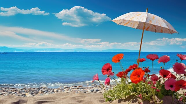 Flowers and umbrella on the beach with blue sky and sea background