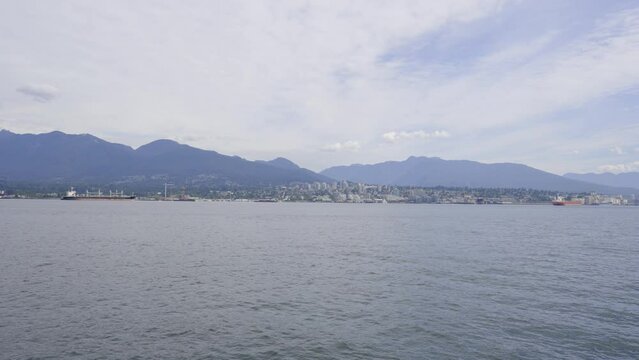 A 4k slow-motion video of North Vancouver and the mountains in the background as viewed from Vancouver Harbour.