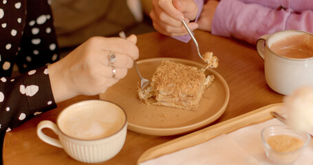 Love and romance. Lesbian Couple Feeding Each Other Cake at Cafe. Intimate moment showcases the love and affection between two adult women, creating a cozy and romantic atmosphere for their date.