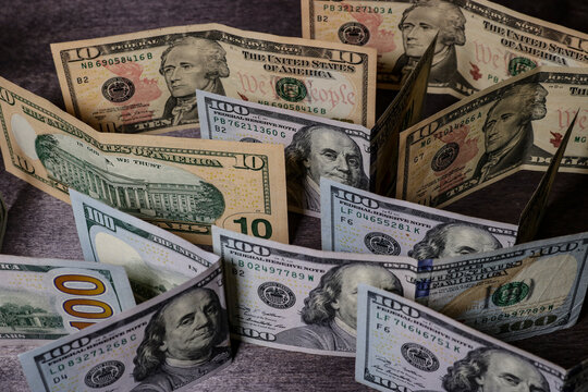 American dollar bills on a dark table. Unusual angle.