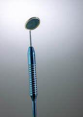 various metal dental instruments on background