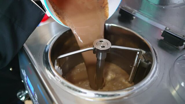 putting mixture into the pasteurization machine rotating to pasteurize icecream. High quality 4k footage