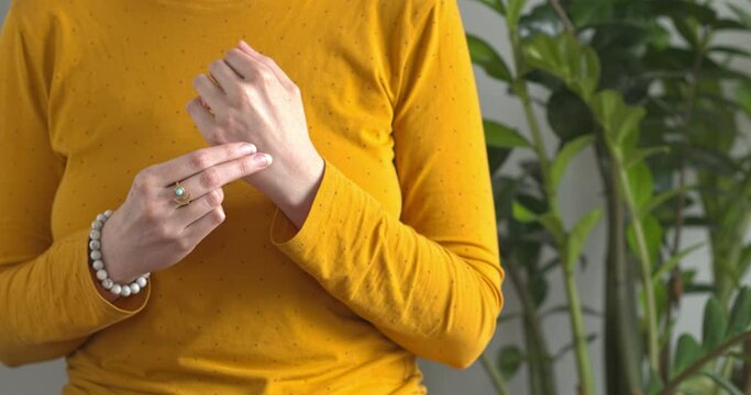 Person practicing EFT. Female tapping gamut point.