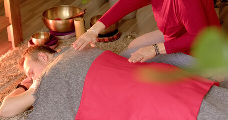 Man during bioenergetic healing session. Energy practices, woman performs energetic movements or...