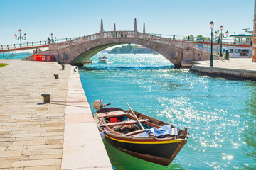 Gondola and bridge over canal and exit to bay. Venice, Italy