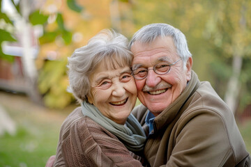 An elderly couple smiling happily together