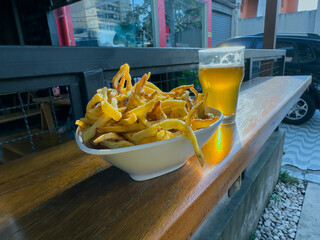 A Portion Of Fries With Beer In The Background.