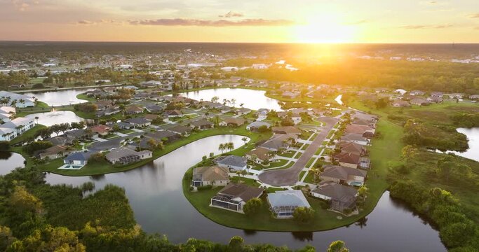 Wealthy waterfront residential area. Rich neighborhood with expensive suburban homes in southwest Florida at sunset