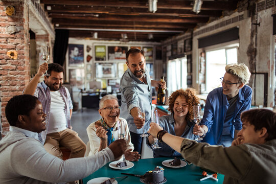 Senior woman celebrating birthday with colleagues in office - Powered by Adobe