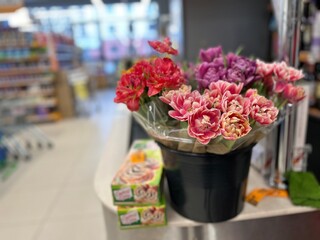 a trading hall with bright terry tulips in bouquets with packaging before International Women's Day...