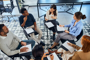 A group of people sitting in a circle during the psychotherapy.