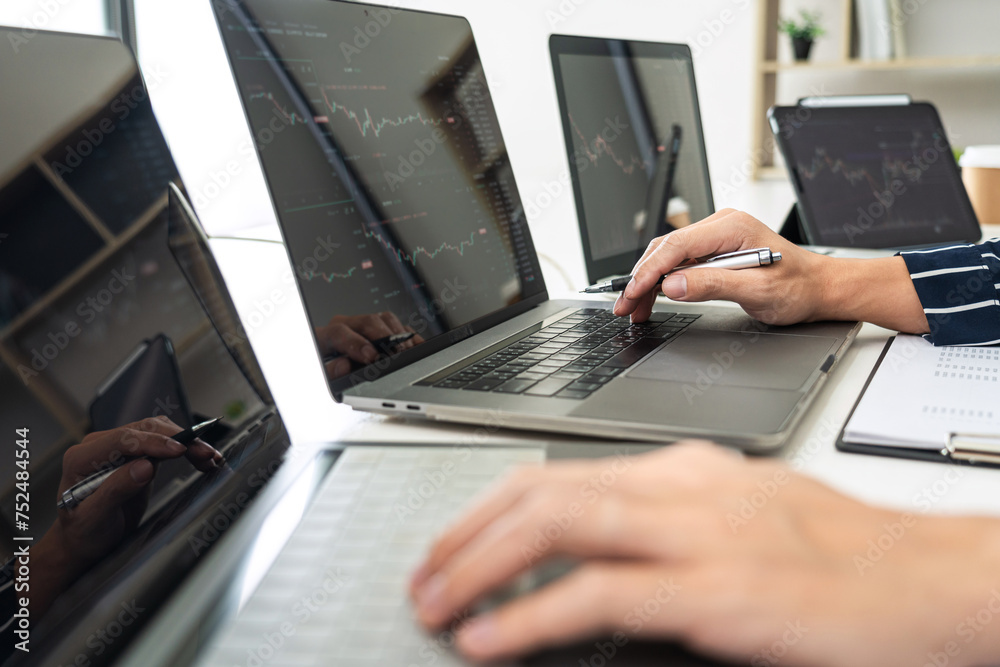 Poster business man trader using laptop to checking stock market online and looking statistics graph on lap