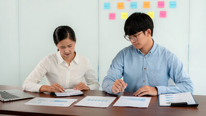 Business executive team brainstorm and takes notes on keyword about a new business project for...