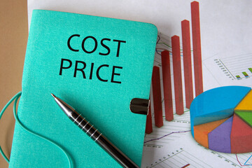 COST PRICE - words on a green piece of paper on the background of a chart and a pen