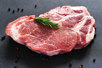 Raw meat steak and raspberry on concrete background. Pork. Rebay beef. With space for text