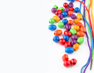 Obraz premium Banner with bright children's toys. A place for text on a white background. Children's beads