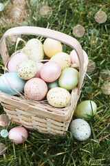 Easter basket with eggs on green grass. Sun rays - 752522129