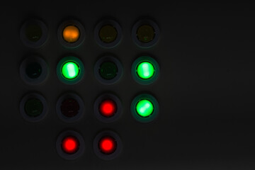 Dark industrial control panel with colorful illuminated buttons