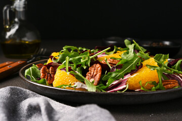 Arugula, orange and pecan salad. Radicchio salad on brown background - 752525548