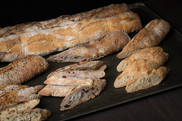 Lots of freshly baked homemade baguette on a black background