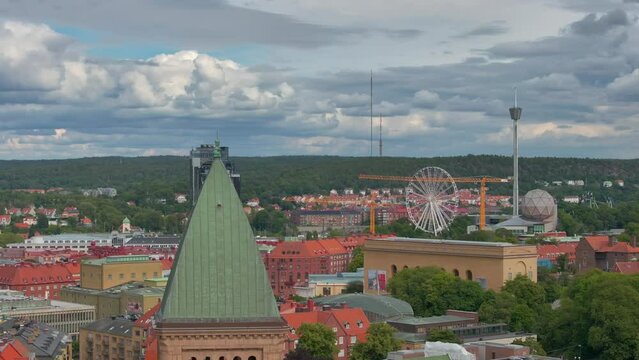 A view of the Vasa church in Gothenburg, Sweden , Amusement park Liseberg in Gothenburg, tower with a cloudy blue sky in the background, Aerial view, Old building , Coastline of Scandinavian city