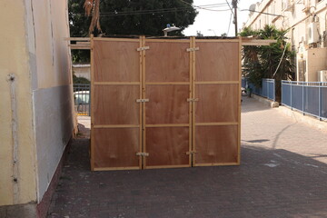 Sukkah for Sukkot from wooden sides and sheets on the street