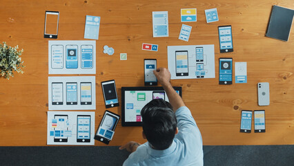Top view of skilled developer walking and placing Ux Ui software. Smart business man put tablet on...
