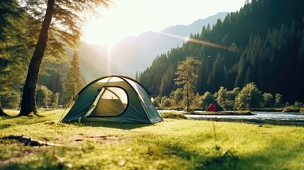 A tent pitched up in the grass next to a peaceful river. Suitable for outdoor and camping themes - obrazy, fototapety, plakaty